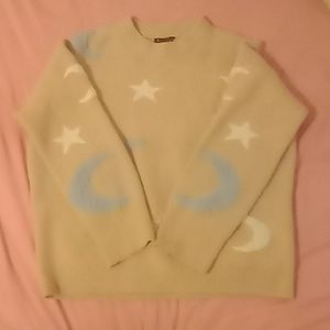 A sweater from Rachel size is a large color pink,blue, and white.